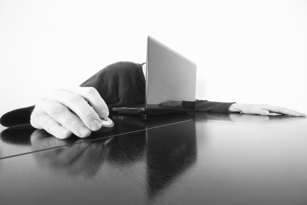 Man with head in laptop.Gives new meaning to always having head in the computer.Focus is mostly on the computer